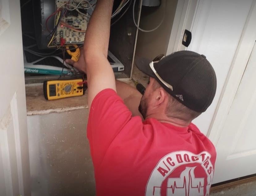 A/C Doctor's contractor working on a furnace.
