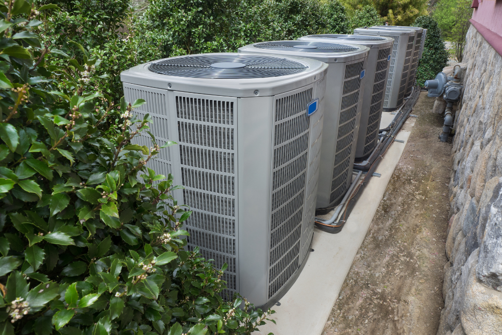 Multiple large hvac units sitting outside the building.